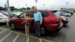 Green Light Auto Customer and Sales Person Shaking Hands in Front of Minivan