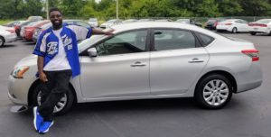 Green Light Auto Happy Customer Leaning On New Car