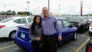 Green Light Auto Customer and Salesperson with Blue Nissan Sentra