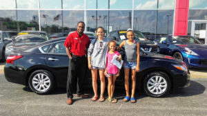 Green Light Auto Salesman with Mother and two Children