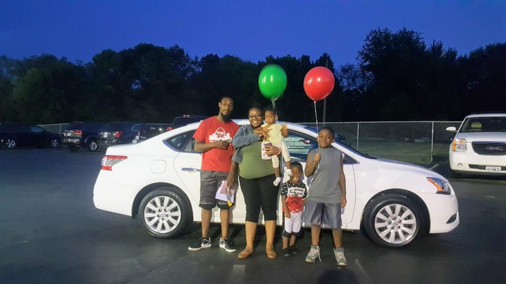 Green Light Auto Parents and children with new white car