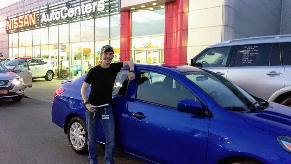 Green Light Auto Customer leaning and smiling with new car