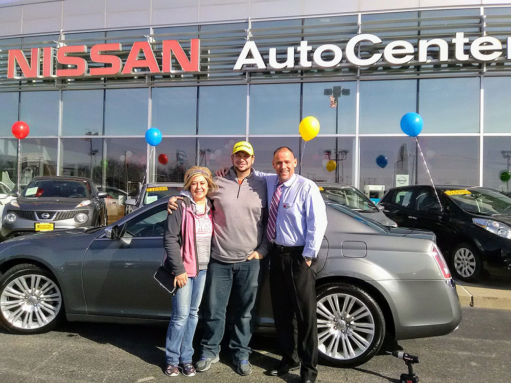 Green Light Two People with Salesperson happy with their Pre Owned 2014 Chrysler 300