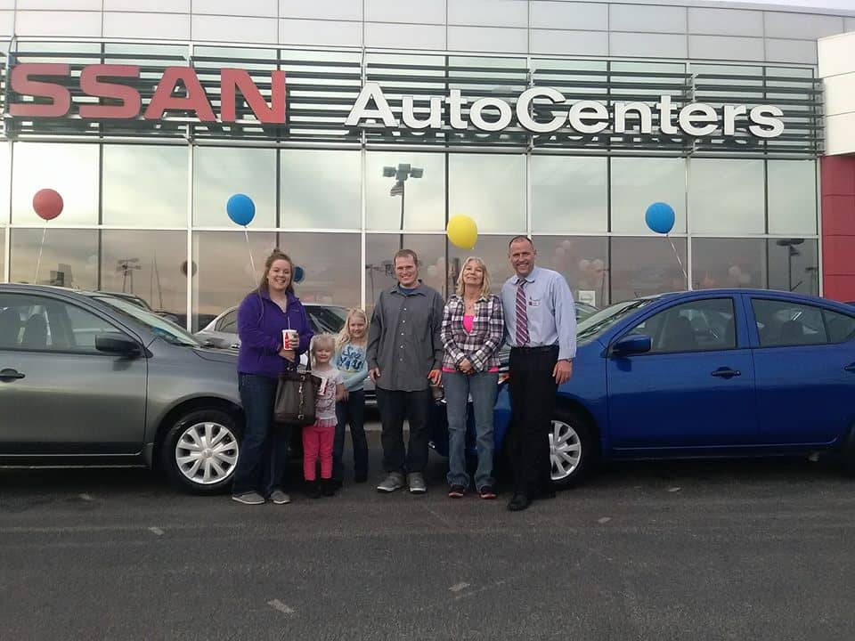 Green Light Auto Five Person Family and Salesperson with new car
